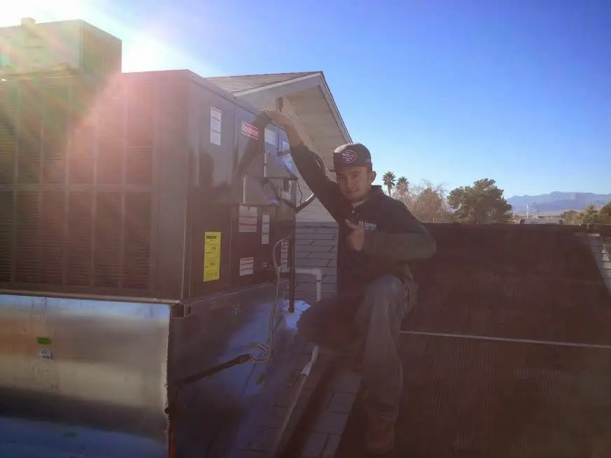 HVAC technician performing HVAC Inspection on a rooftop unit in Memphis